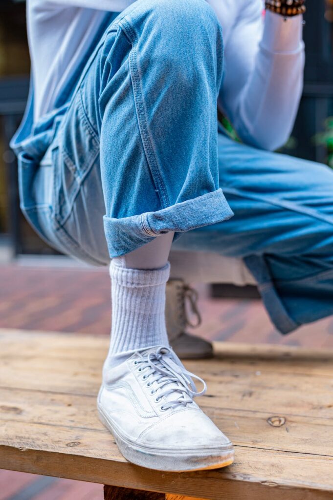 person wearing blue jeans and white socks